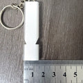Silver and gold aluminium alloy double hole outdoor survival whistle.