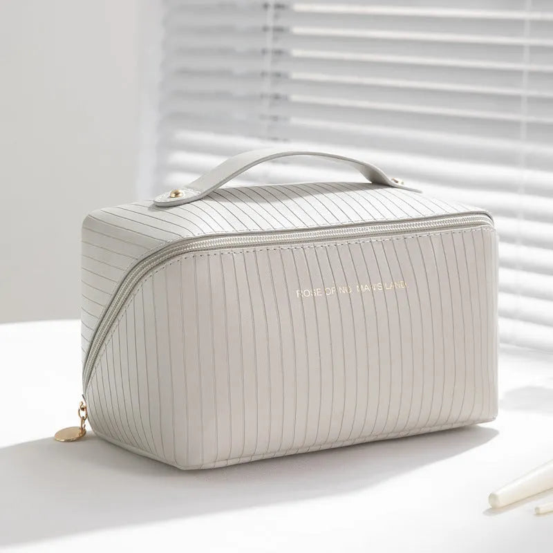Vertical pattern cubic PU makeup bag in beige, 22.5cm length, for travel cosmetics storage.