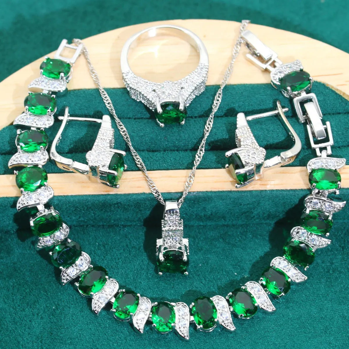 Four-piece bridal jewellery set showing zircon necklace, bracelet, earrings, and ring in coordinating design