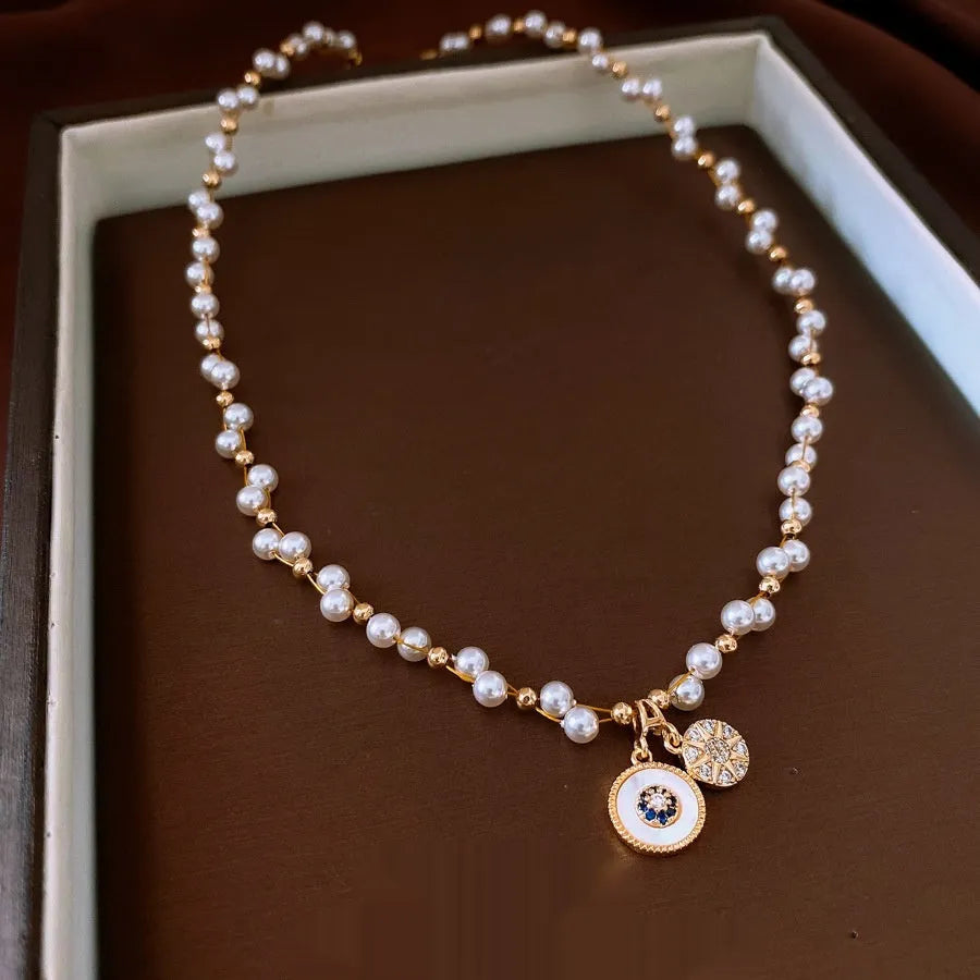 Gold electroplated women's necklace with round pearl pendant and adjustable clavicle chain