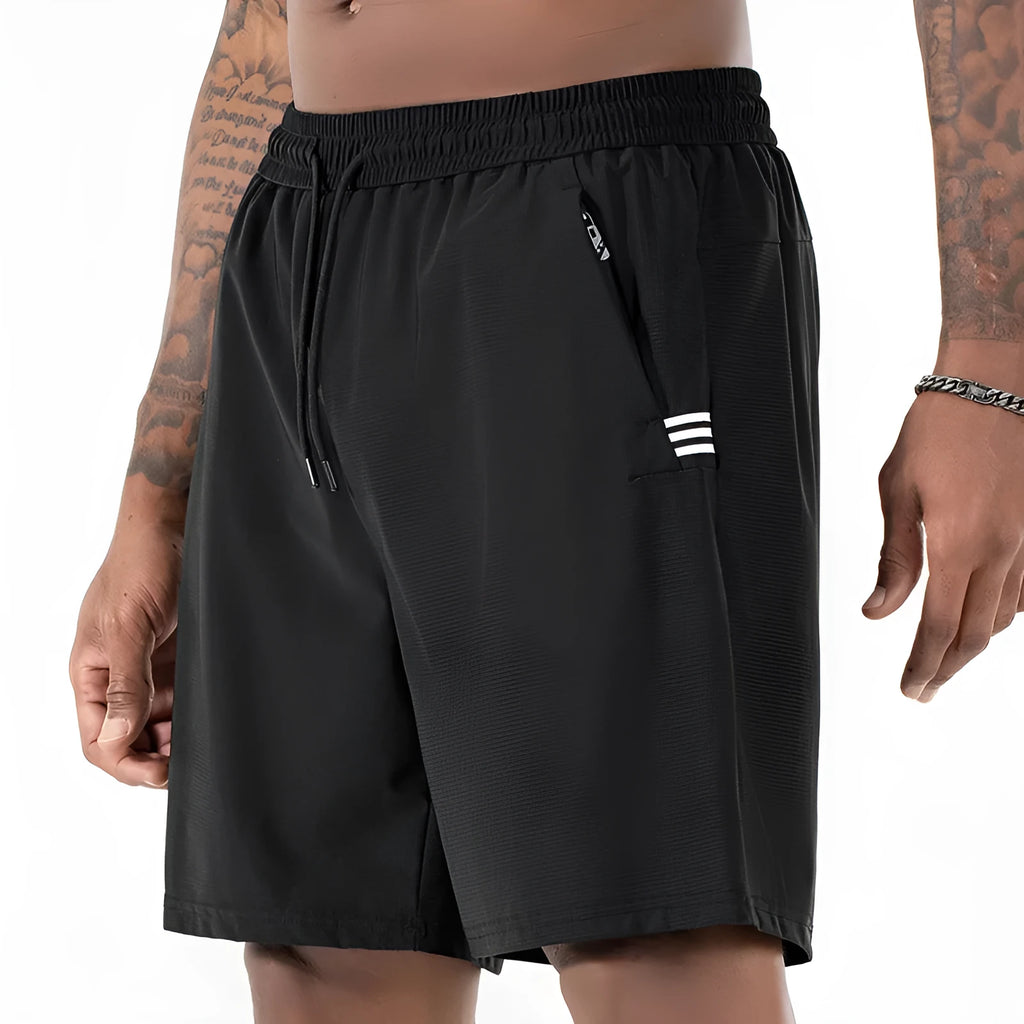 Man wearing black ice silk sport shorts with a high waist and cropped length.