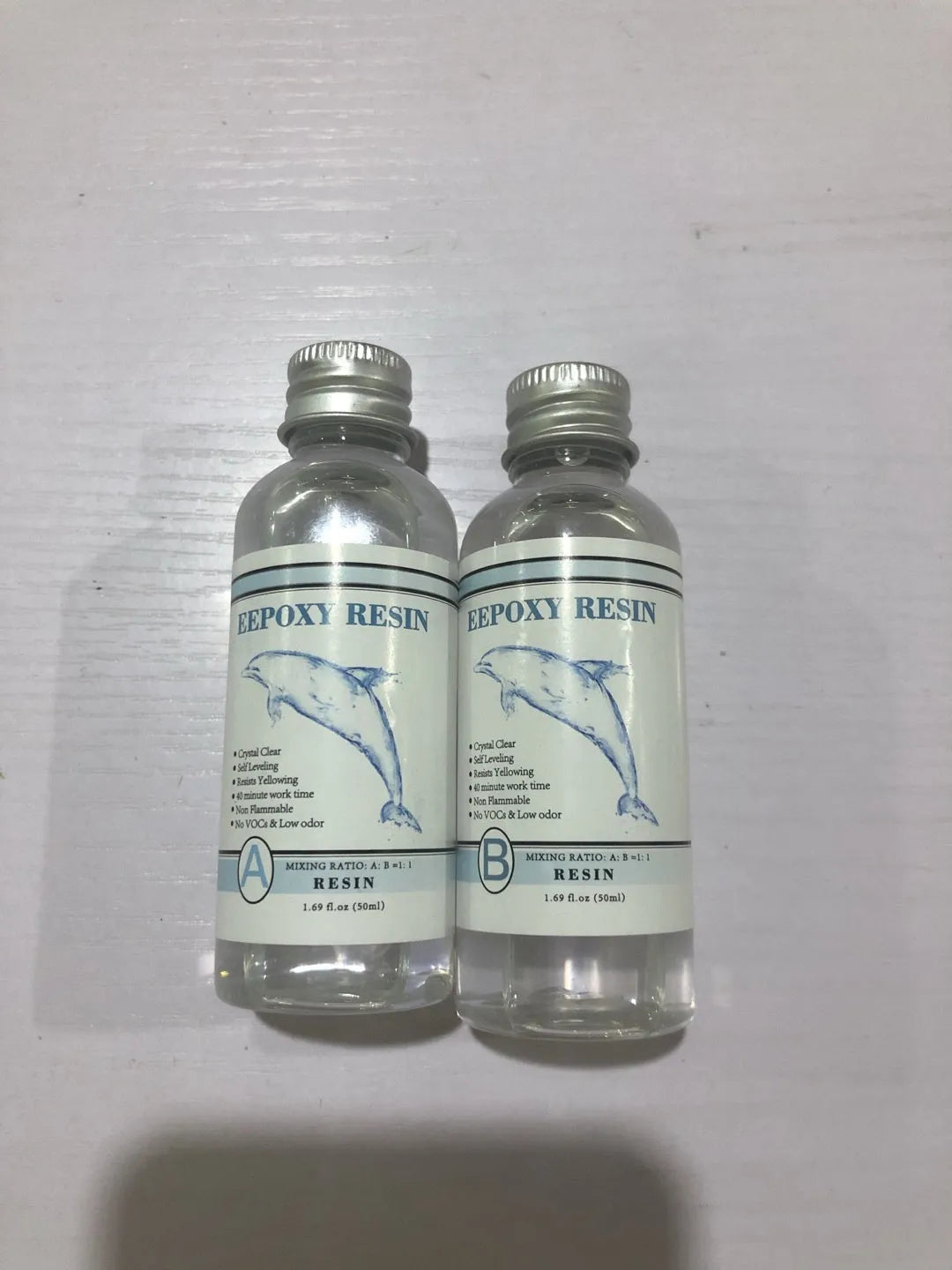 Quick-curing AB epoxy resin kit with two bottles for DIY jewellery and craft projects.