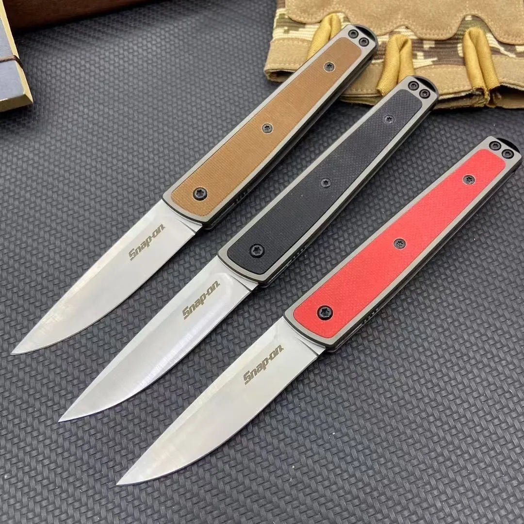 Closed and opened views of a black folding fruit knife showing the stainless steel blade and handle.