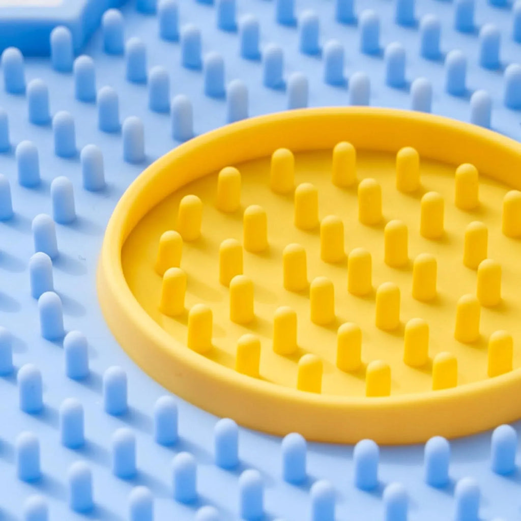 Flower-shaped silicone pet lick mat with suction cups on the base, shown in a choice of colours.