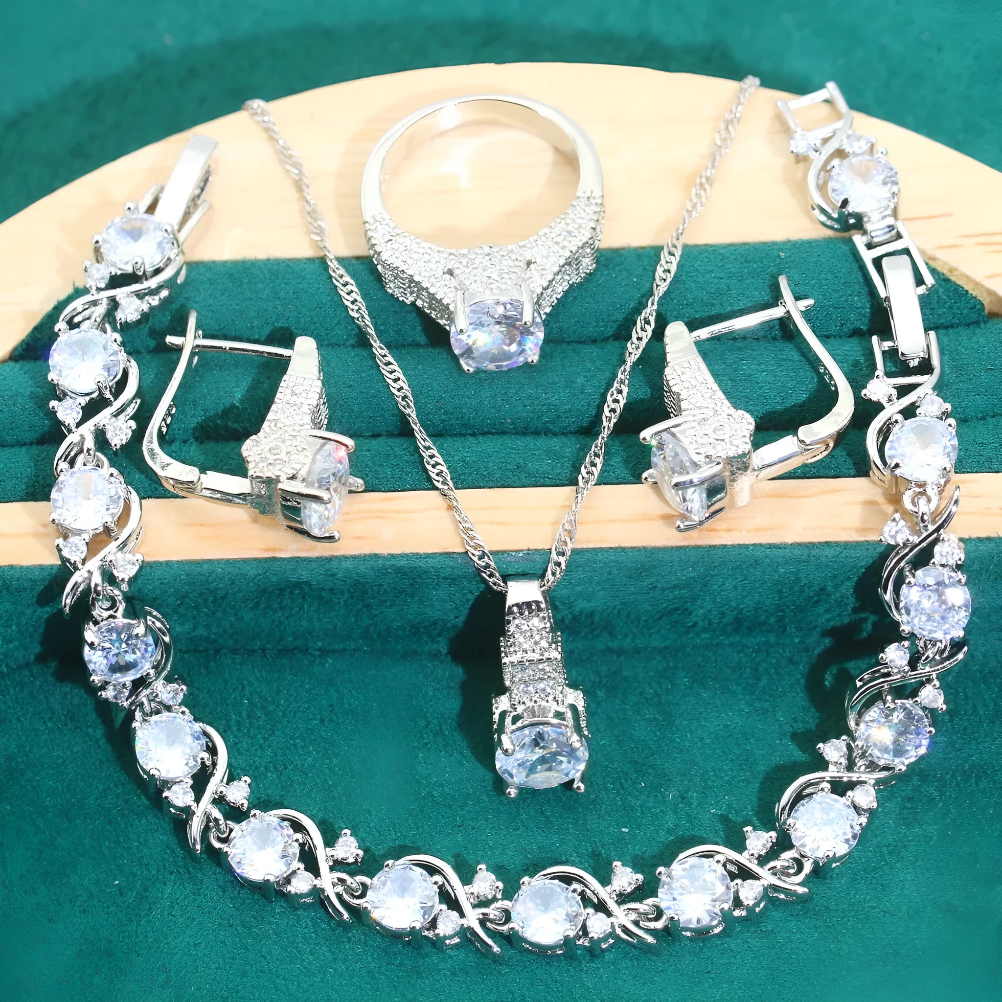 Four-piece bridal jewellery set showing zircon necklace, bracelet, earrings, and ring in coordinating design