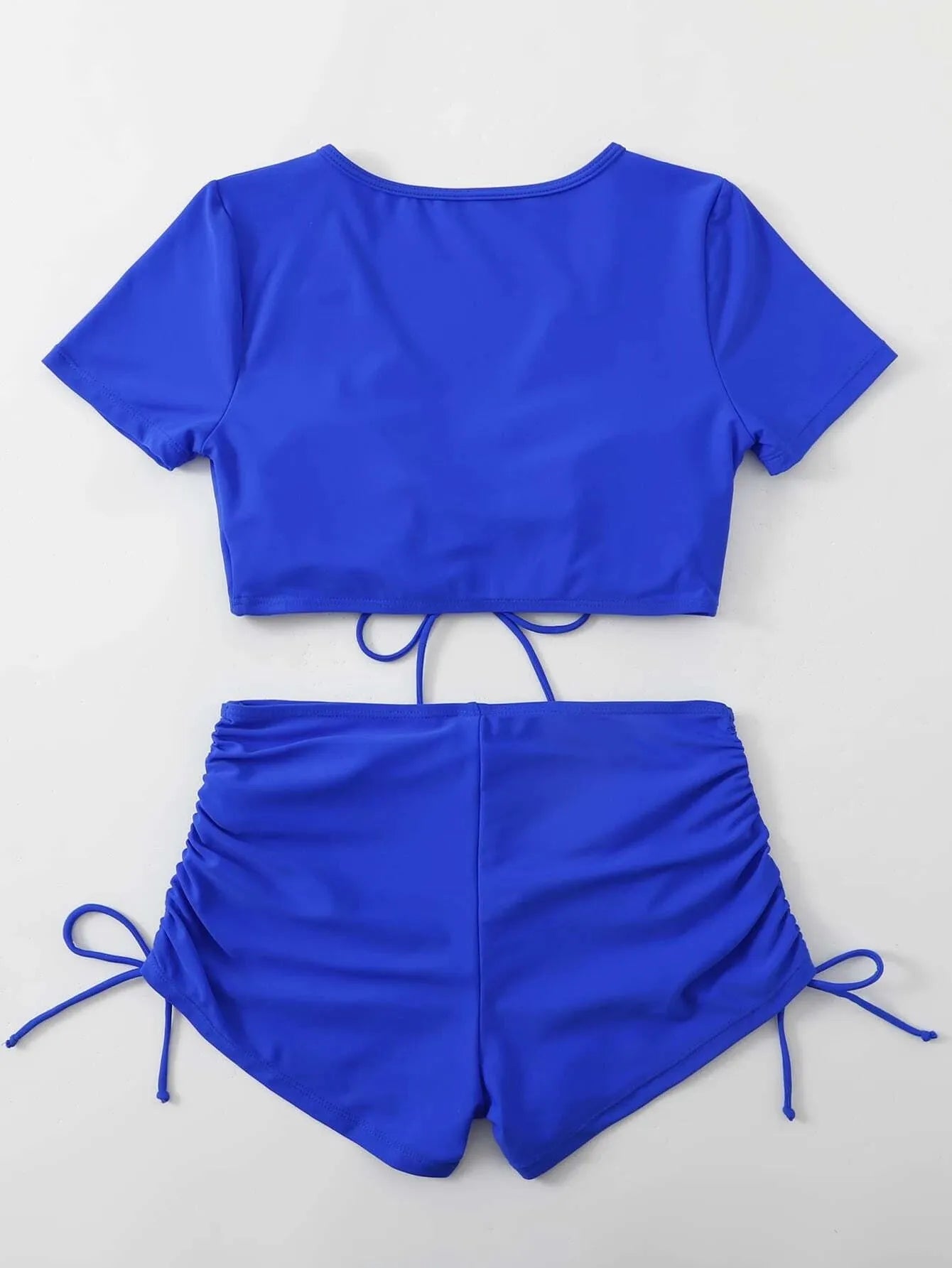 Lady's black lace-up bow two-piece swimsuit top and shorts set on a mannequin