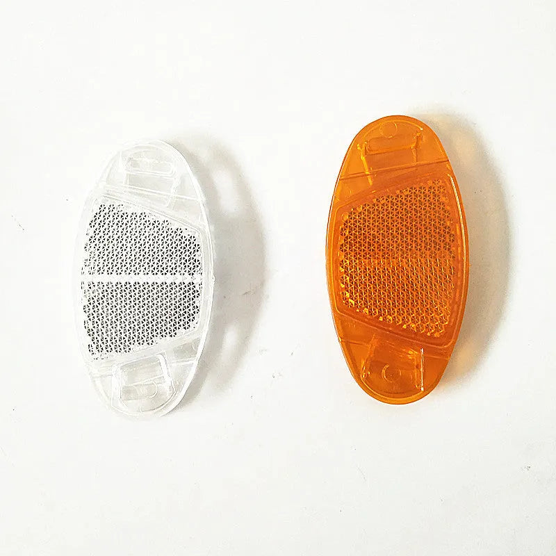 White and yellow plastic bicycle spoke reflectors measuring 7.2cm long by 3.5cm wide for night safety