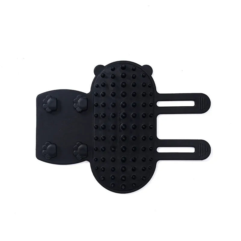 Silicone cat grooming massage comb with adjustable strap mounted on furniture leg