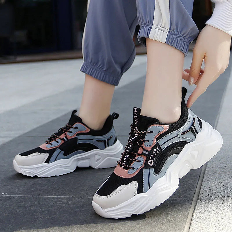 Women's white mesh casual trainers with a thick sole, round toe, and a buckle fastening detail.