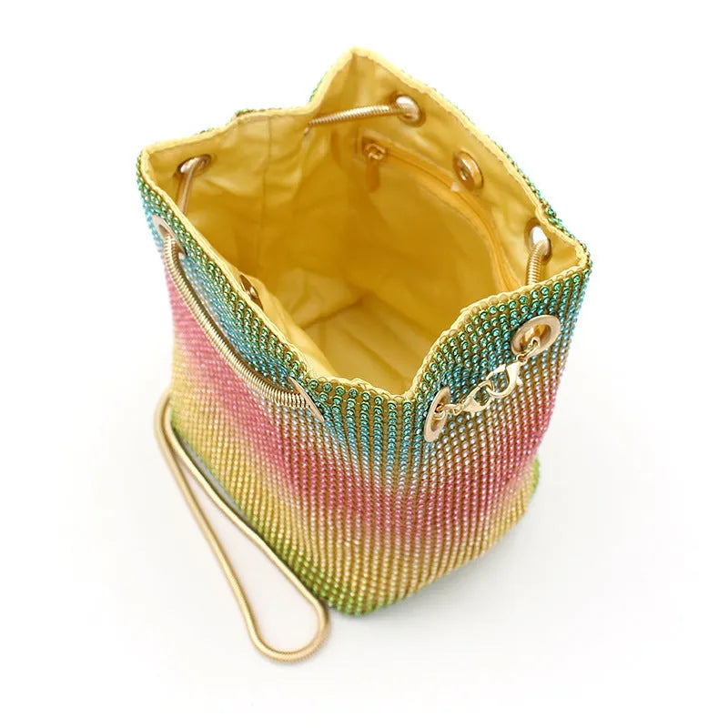 Rhinestone bucket bag with diamond studded design and rainbow chain strap