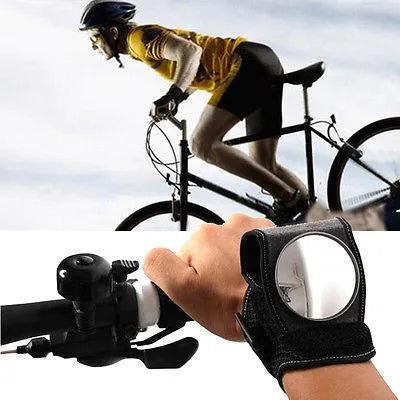 Bicycle wrist safety mirror with adjustable strap and anti-slip pad on a cyclist's wrist