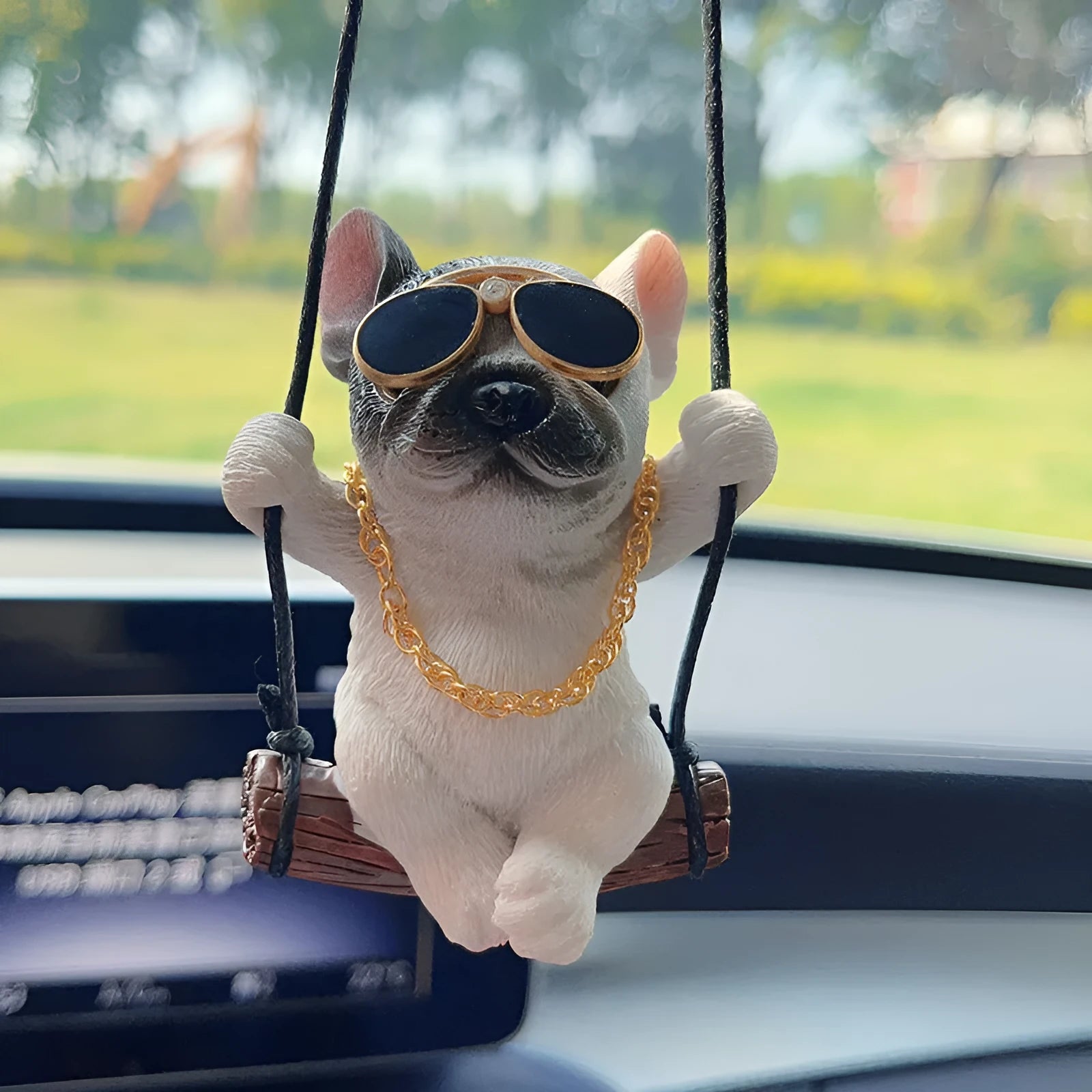 Cartoon-style resin bulldog car pendant hanging from a rearview mirror.