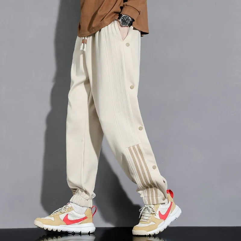 Men's black sports sweatpants with high waist, drawstring closure and ankle ties in cotton blend fabric