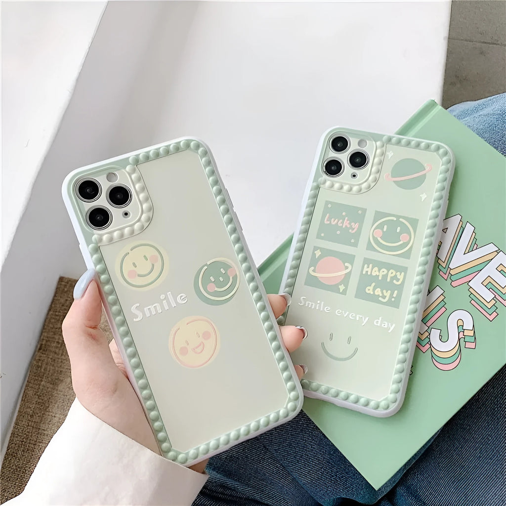Green TPU iPhone case with geometric shapes and smiley faces inside a polka dot frame.