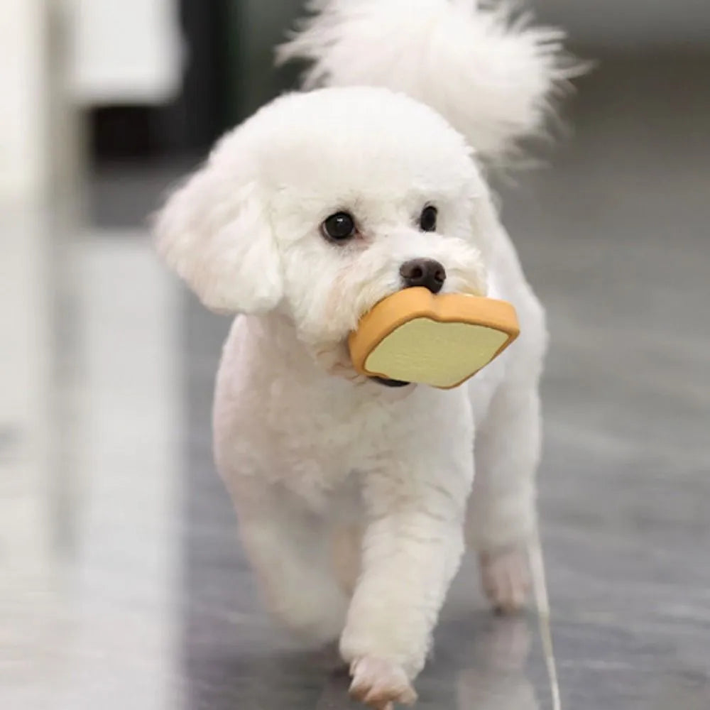 Yellow latex dog chew toy shaped like cartoon bread with squeaker inside