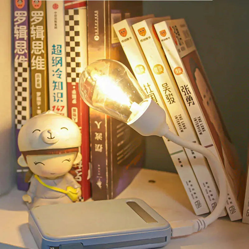 USB rechargeable folding night light with warm tungsten bulb illuminated.
