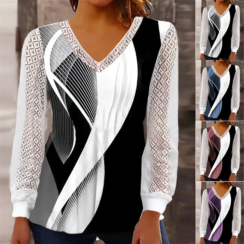 Purple loose V-neck top with lace print detail and long sleeves on a hanger.