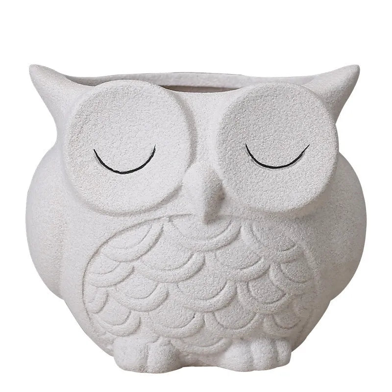 Handmade frosted ceramic flower pot with a cartoon owl design, shown in light pink.