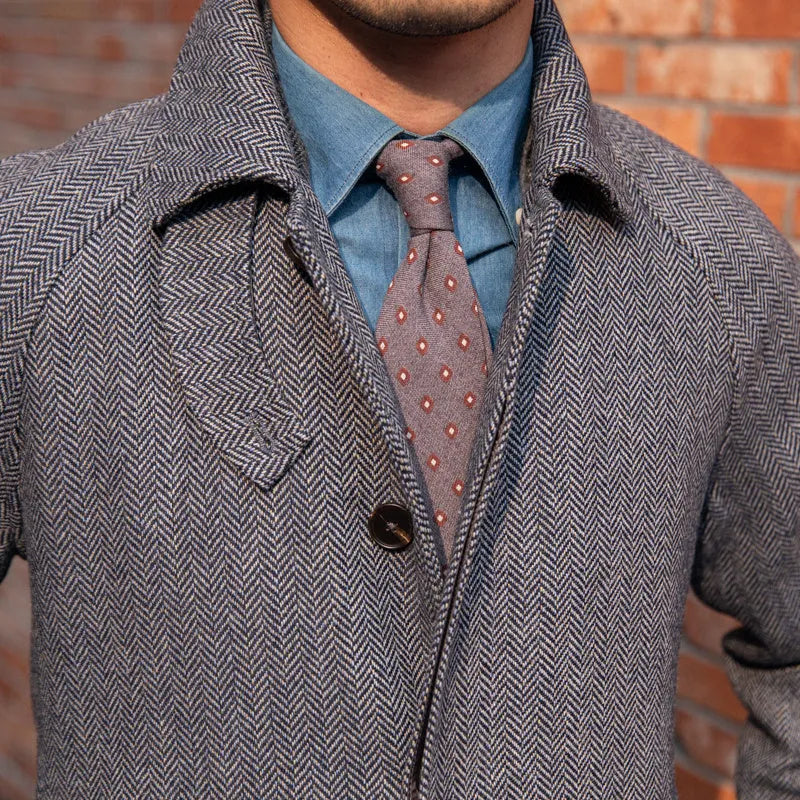 Men's herringbone wool slim fit mid length coat in blue with lapel collar and single-breasted placket