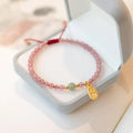 Hand-woven red rope bracelet with strawberry quartz crystal lucky charm