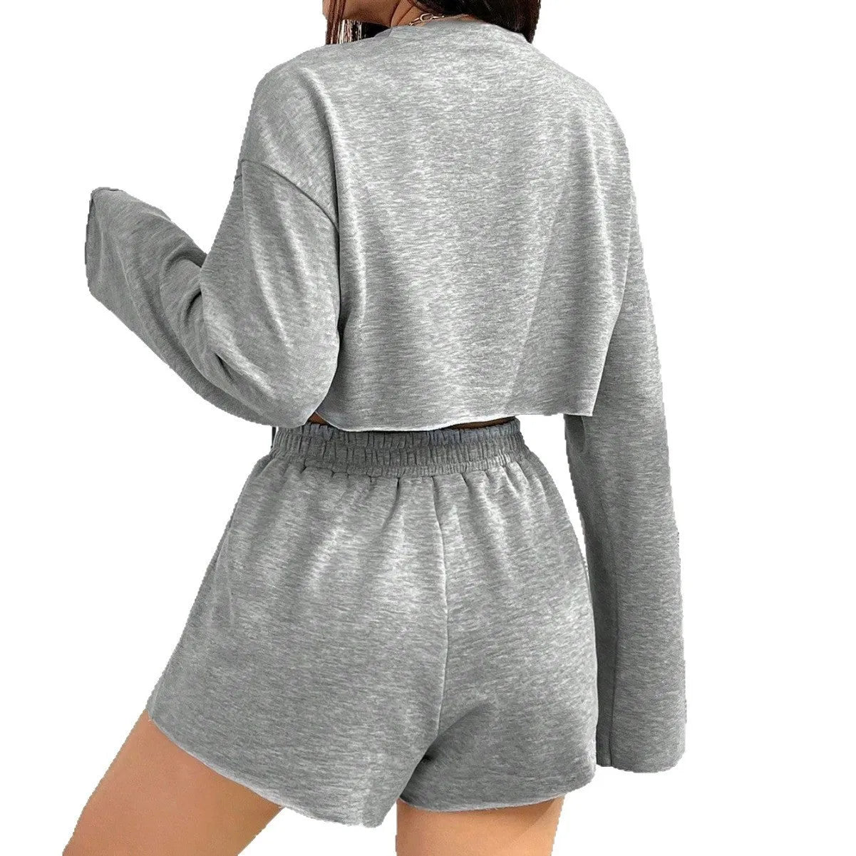 Grey women's long-sleeved t-shirt and matching shorts loungewear set laid flat.