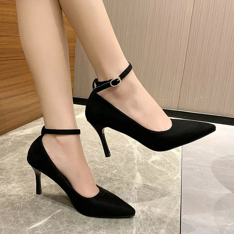 Women's black stiletto heel pumps with buckle detail and skull pattern lining