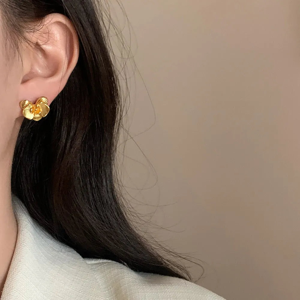 Retro flower earrings with gold or silver electroplated finishes and detailed petal design elements