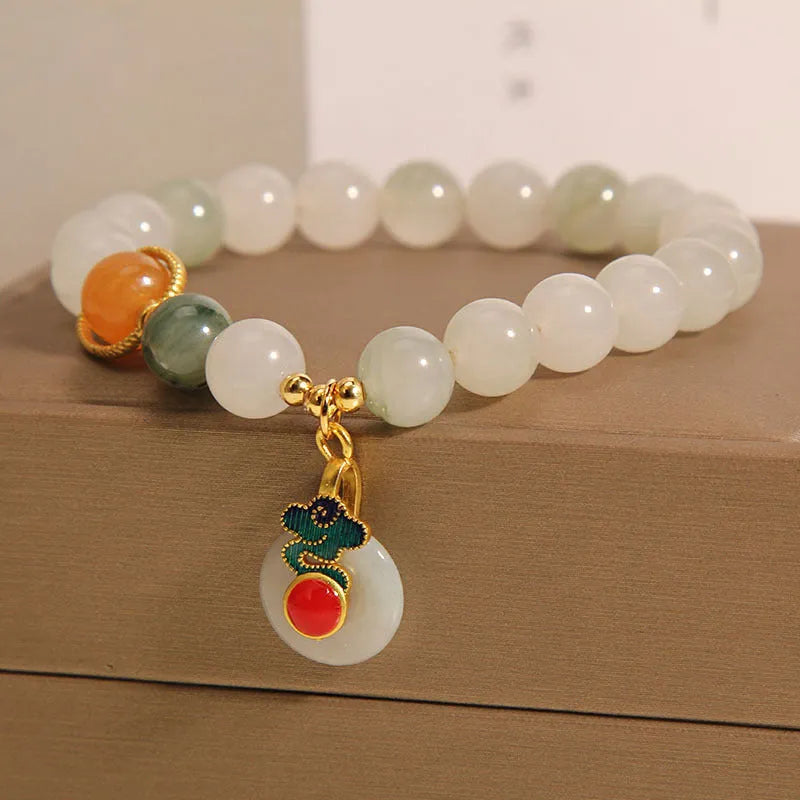Women's ice jade crystal bracelet with Xiangyun peace buckle and pearl details.