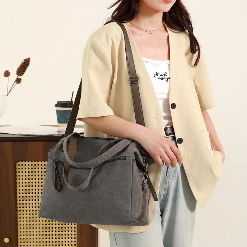 Grey retro-style canvas women's handbag with large capacity and internal pockets.