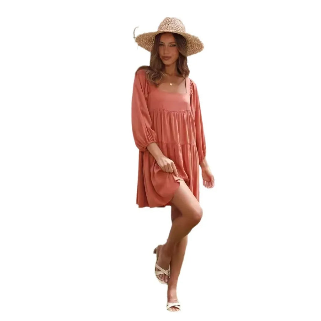 Orange backless children's dress with a square collar and puff sleeves in an A-line silhouette.