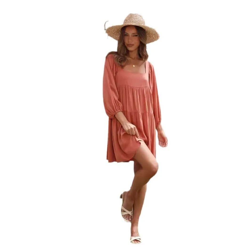 Orange backless children's dress with a square collar and puff sleeves in an A-line silhouette.