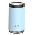 Blue jellyfish-shaped USB humidifier emitting smoke ring mist with warm night light on, placed on a wooden desk.
