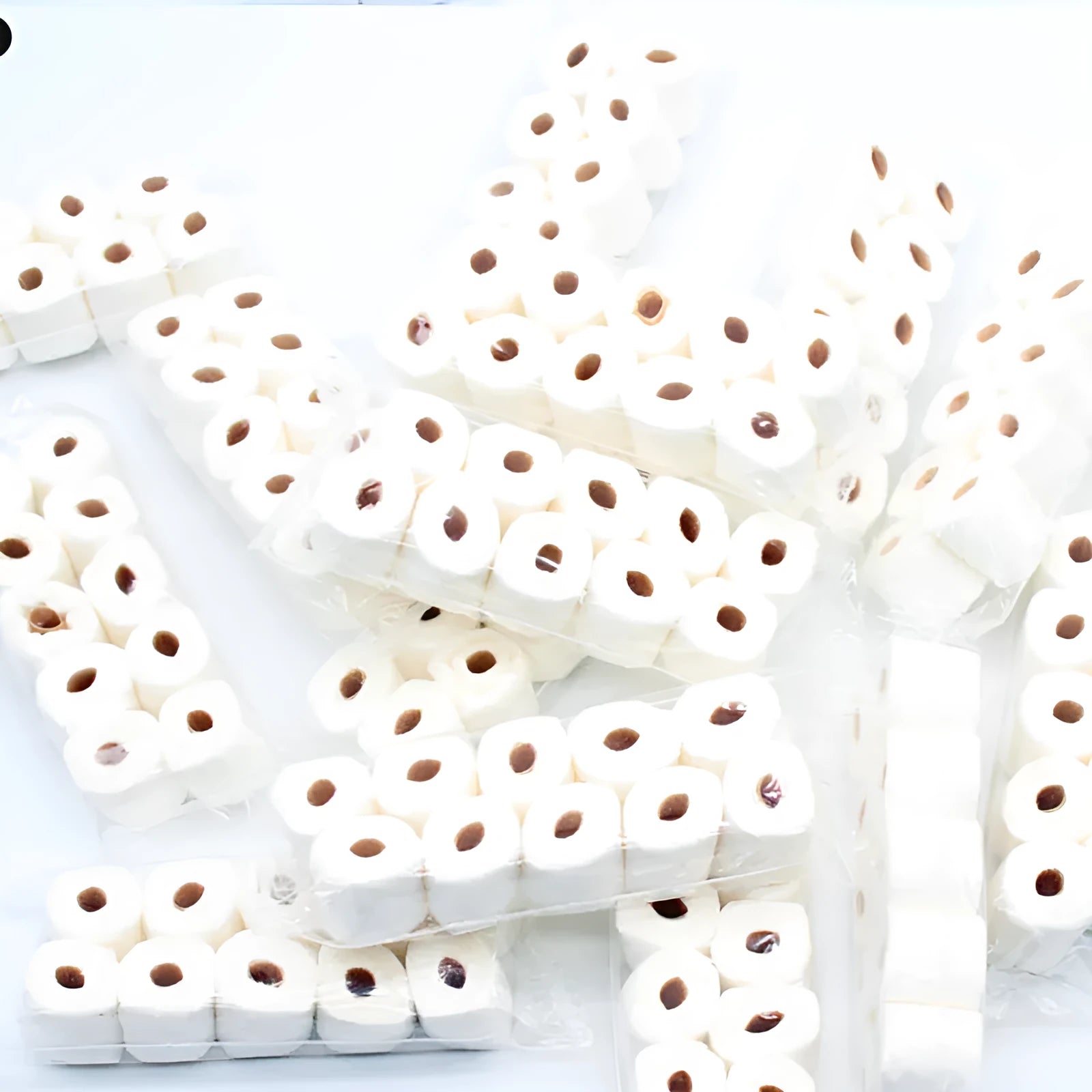 Miniature simulated toilet paper roll model made from paper for dollhouse and children's pretend play.