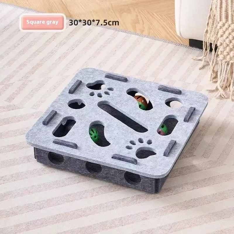Green brown felt cube cat scratching toy with a square hole in the centre panel.