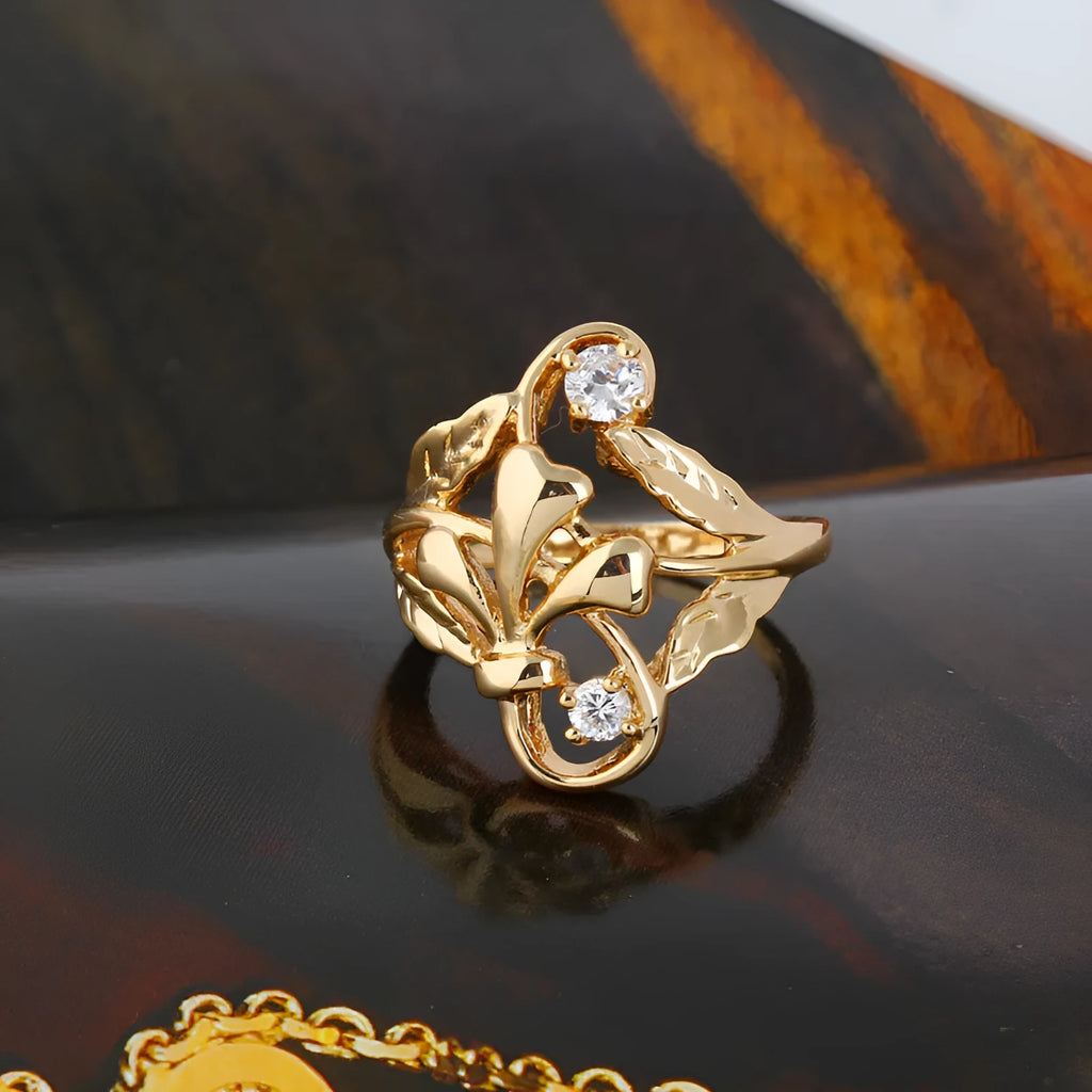 Gold tone copper ring with irregular leaf shape and white zircon crystal on geometric band, women's fashion jewellery