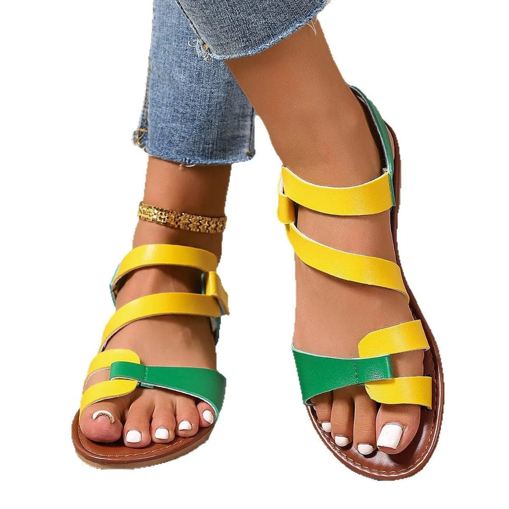Women's flat sandals with Velcro strap in black, brown, and colourful options on a rubber sole.