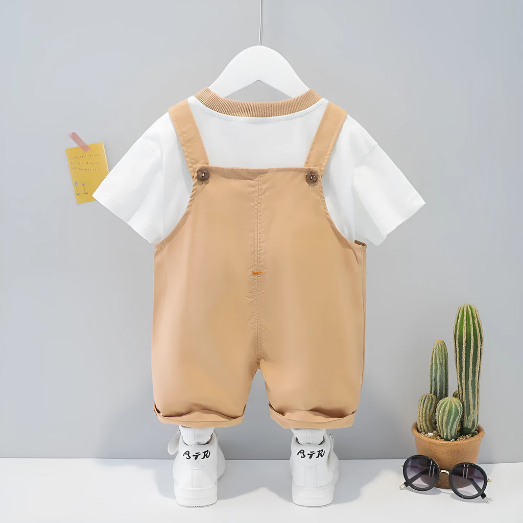 Cotton baby overalls with cartoon print in khaki colour, showing front opening with straps and short sleeves