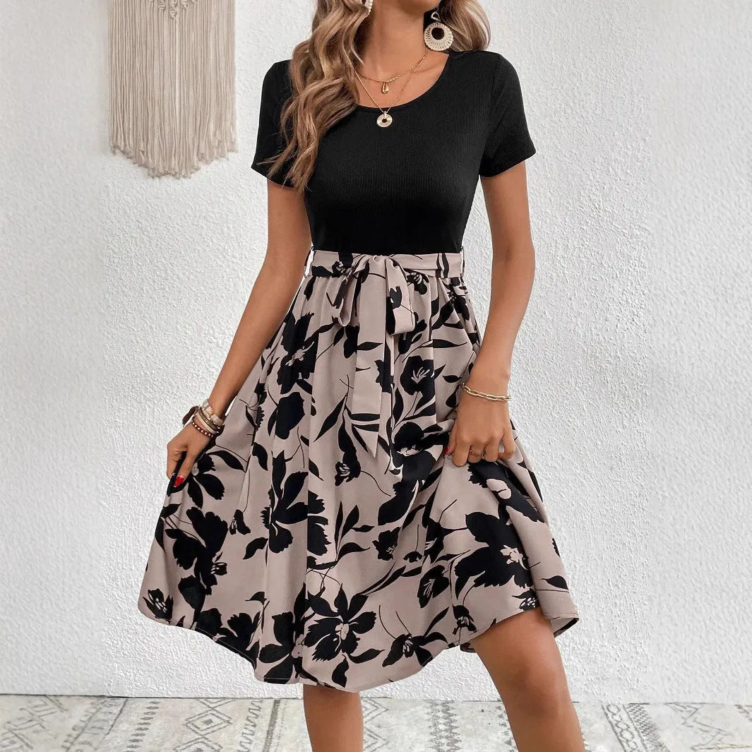 Khaki women's A-line dress with floral plant pattern printing and a shoulder strap detail.