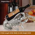 Lobster-shaped wine rack ornament in rose gold or silver holding a wine bottle