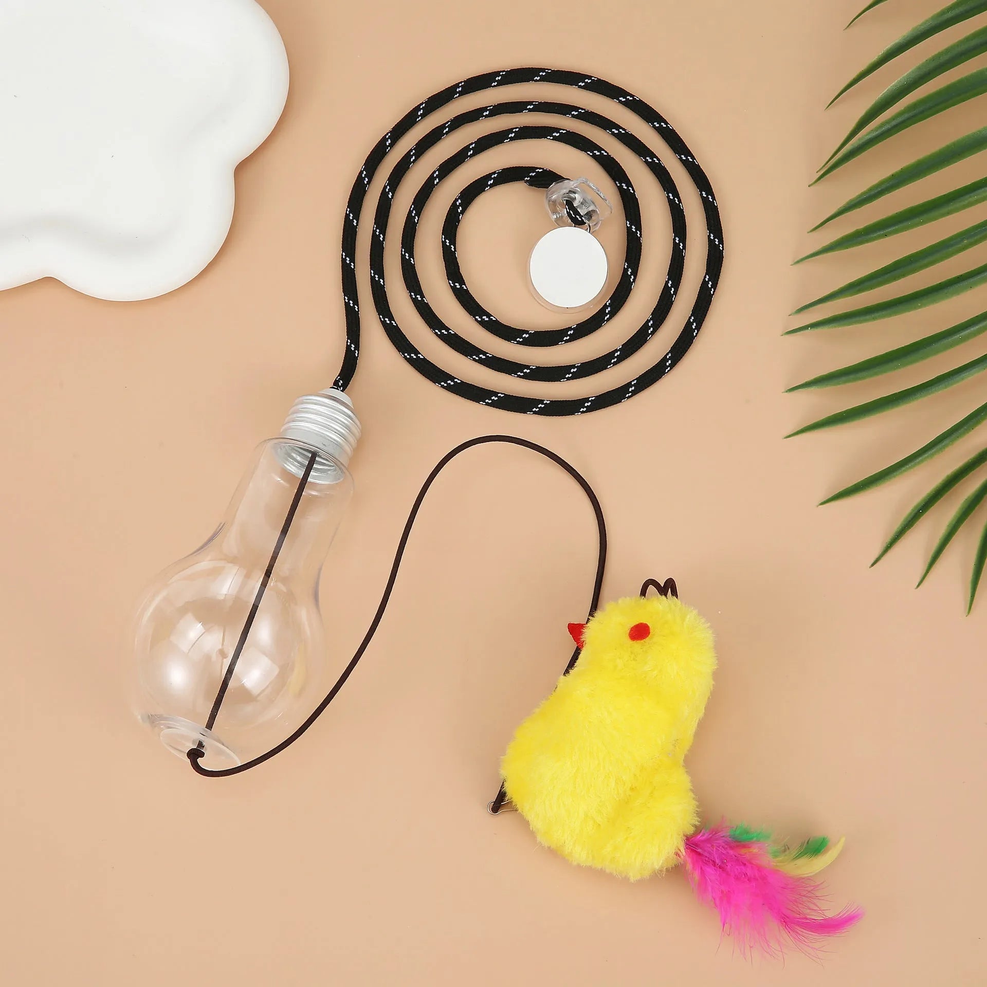 Interactive cat toy hanging on door frame with retractable rope, swinging attachments and treat reward bulb