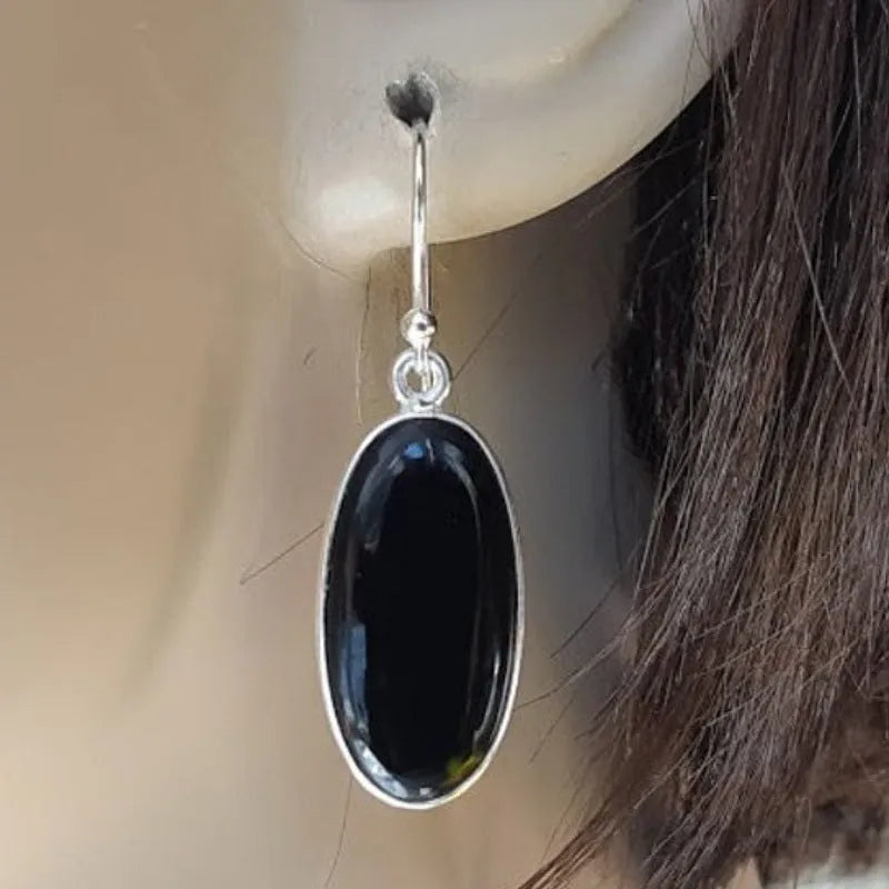Women's geometric drop earrings with oval black agate pendant in silver setting
