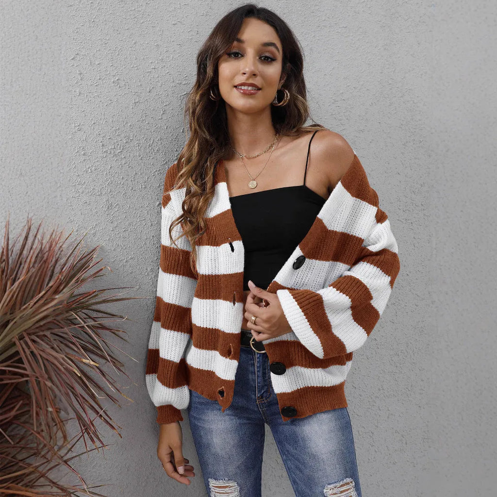 Blue striped women's cardigan with button front and deer plush textured fabric on a hanger.