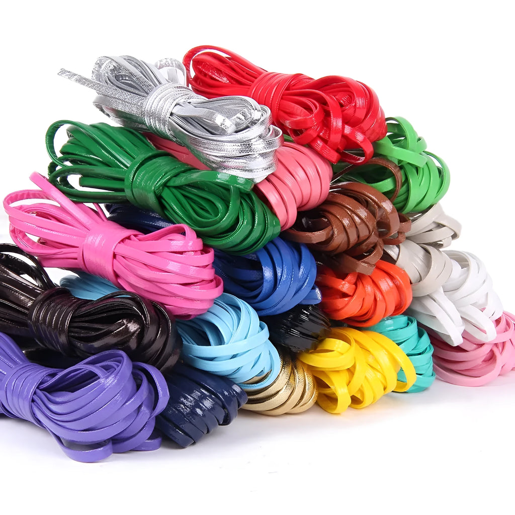 Coiled PU leather craft strings in multiple colours showing black, red, blue, and gold cords