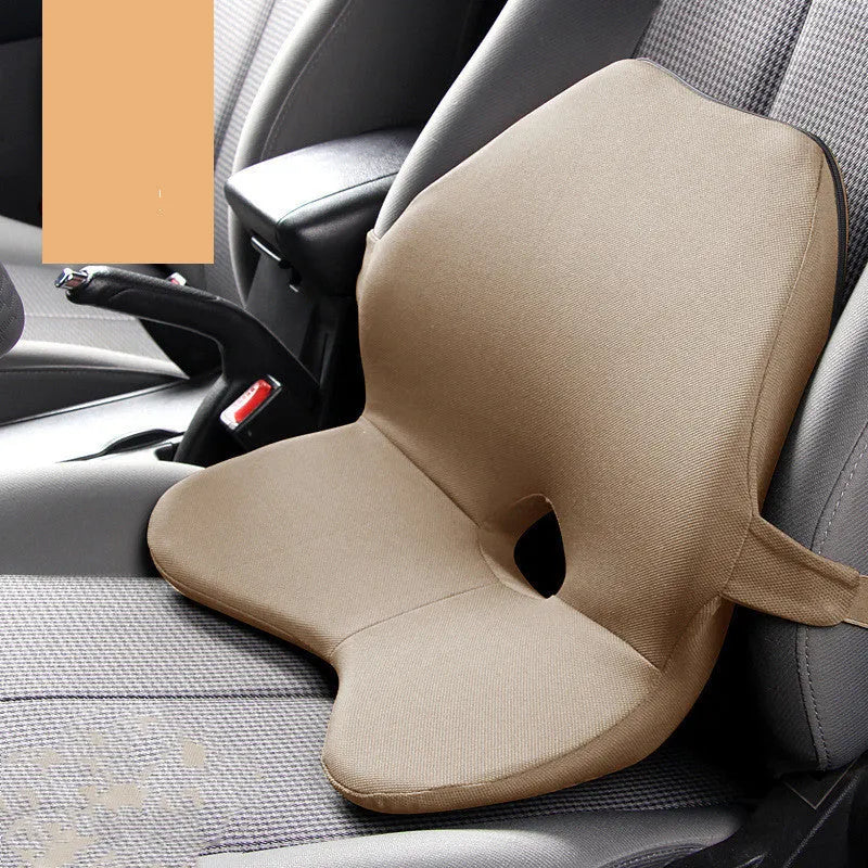 Black memory foam car lumbar support cushion with elastic straps, shown on a grey car seat.