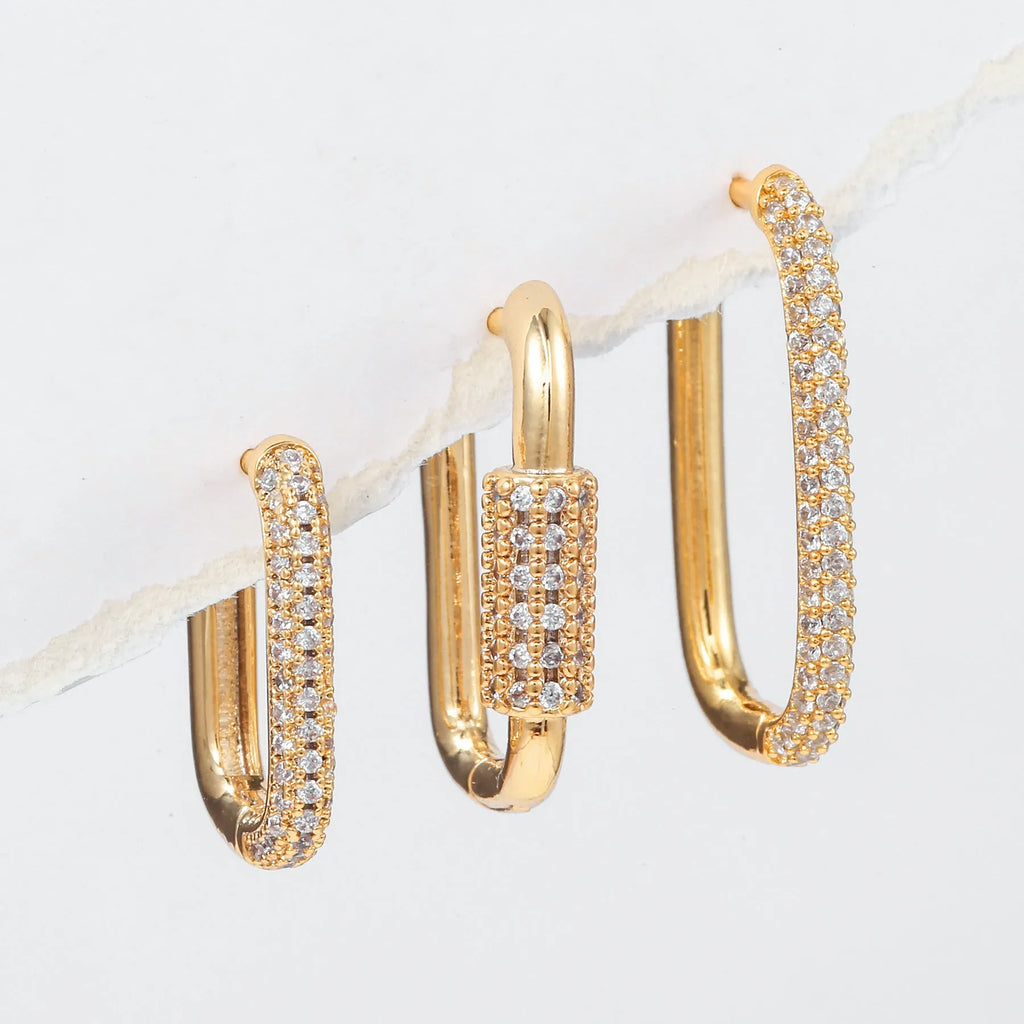 Three geometric copper ear clips with micro inlaid zircon stones in gold and white gold finishes