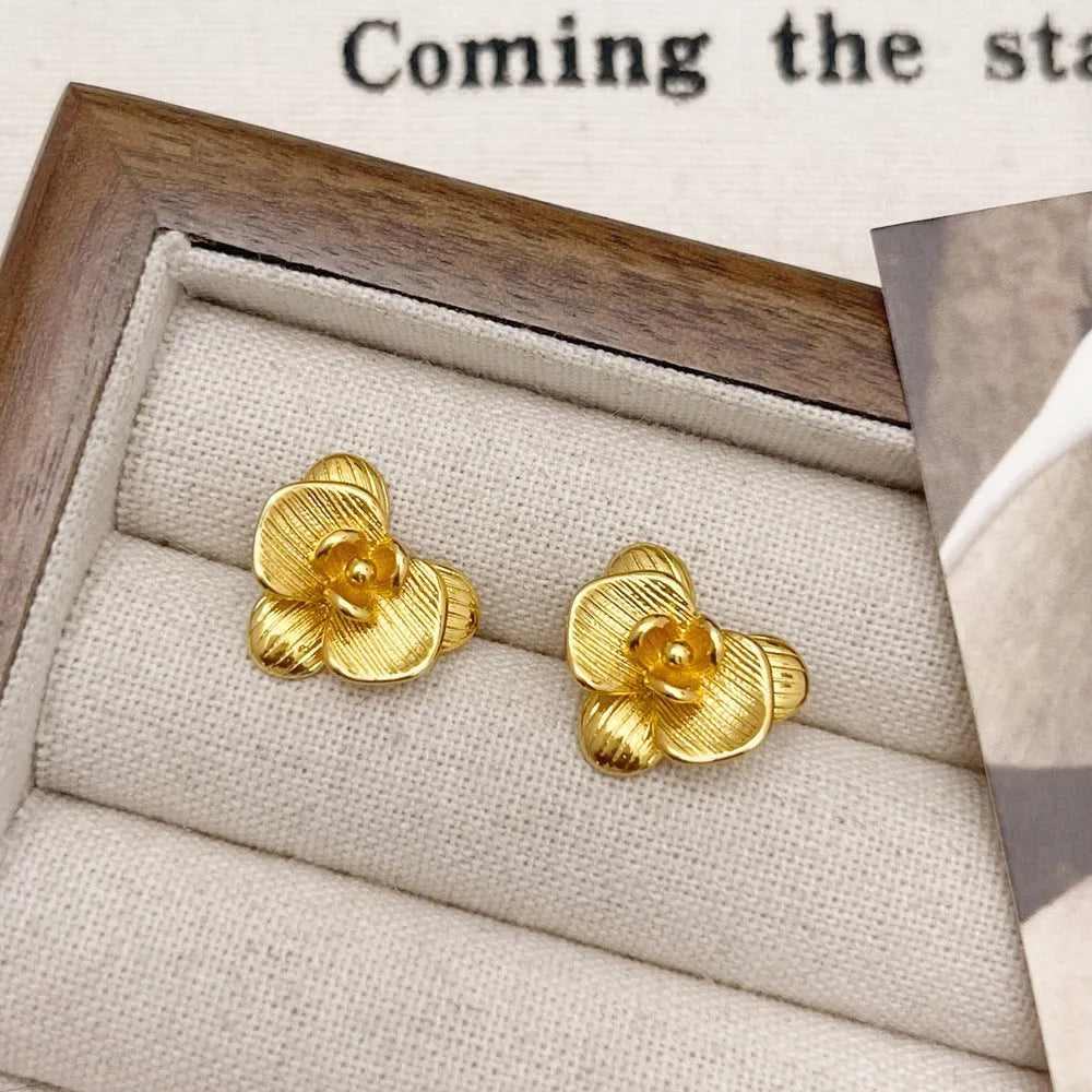 Retro flower earrings with gold or silver electroplated finishes and detailed petal design elements