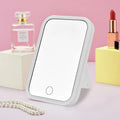 Square LED makeup mirror with smart touch light in pink colour, plastic frame, silver mirror lens