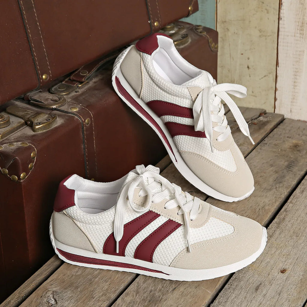 Wine red Cortez Retro sneaker with mesh upper, cross strap, and flat rubber sole.