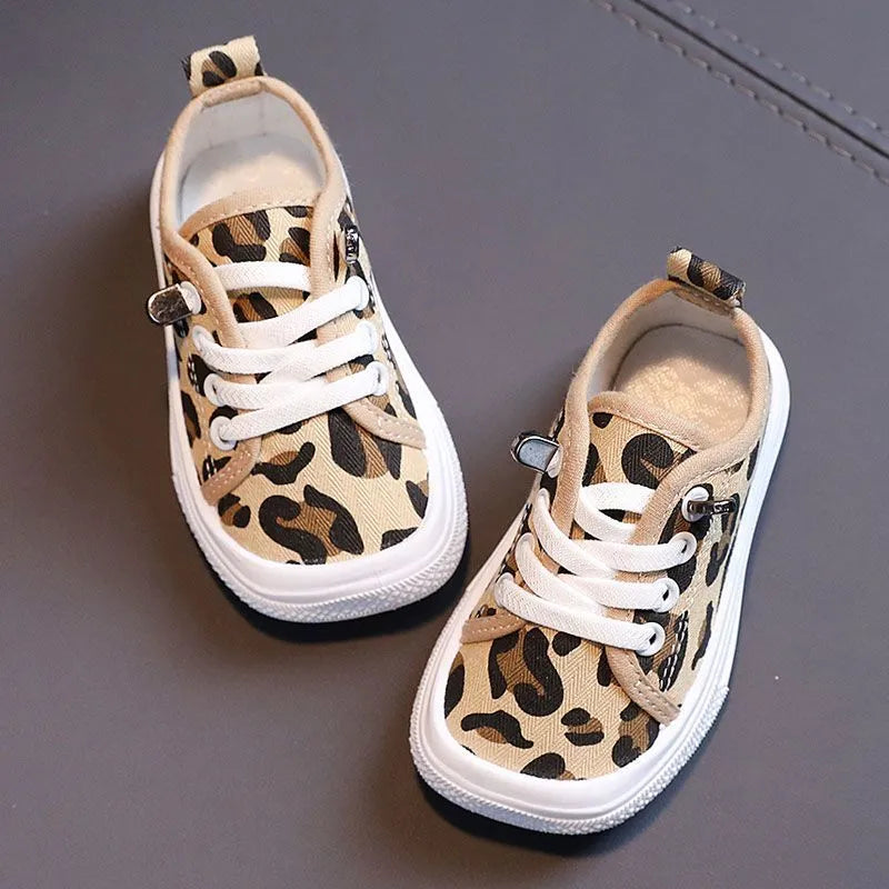 Children's canvas shoes low top sneakers in orange black white leopard print and plaid on a white background