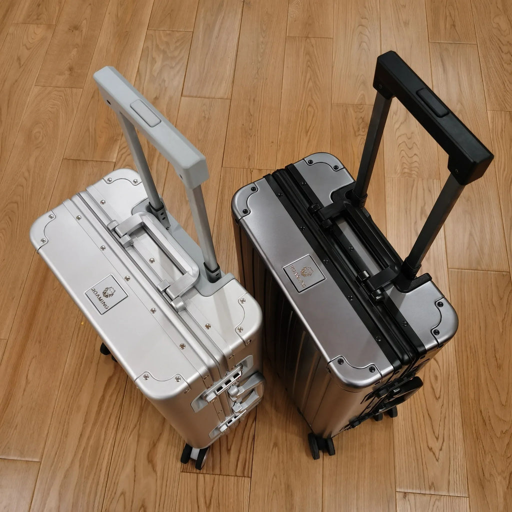 Aluminium magnesium alloy hard-shell travel luggage in a striped design, shown in silver finish.
